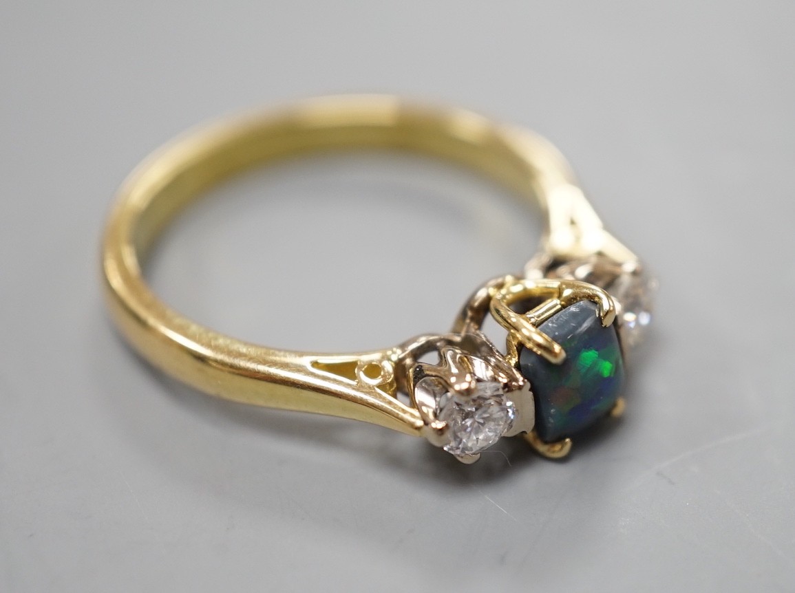 A modern 18ct gold, black opal and diamond set three stone ring, size Q, gross weight 4.6 grams